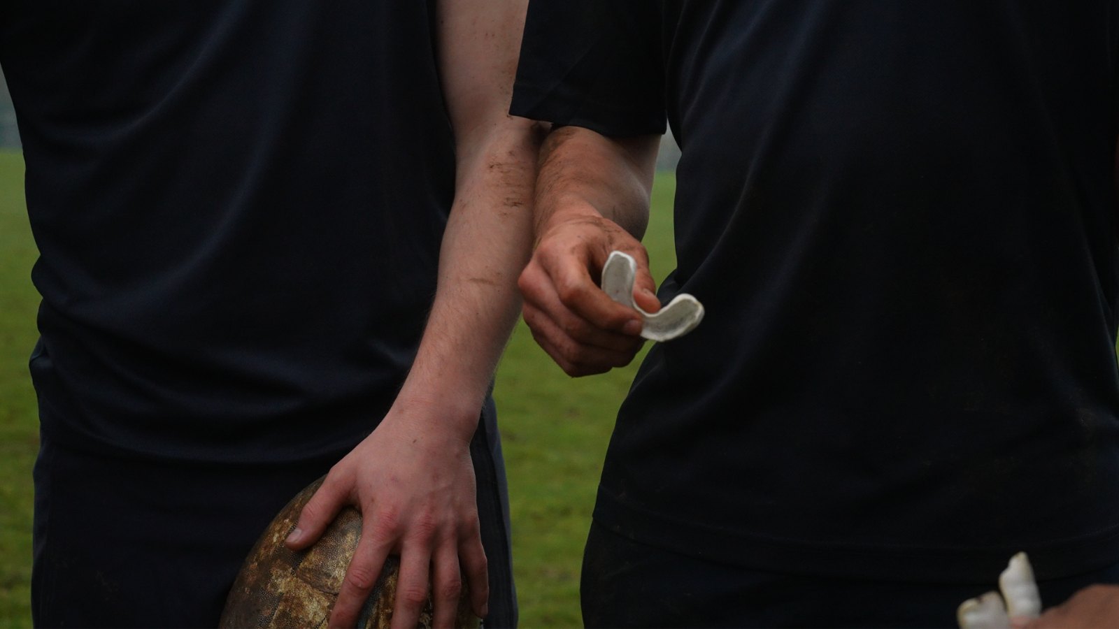 Player holding a Prevent mouthguard on the pitch