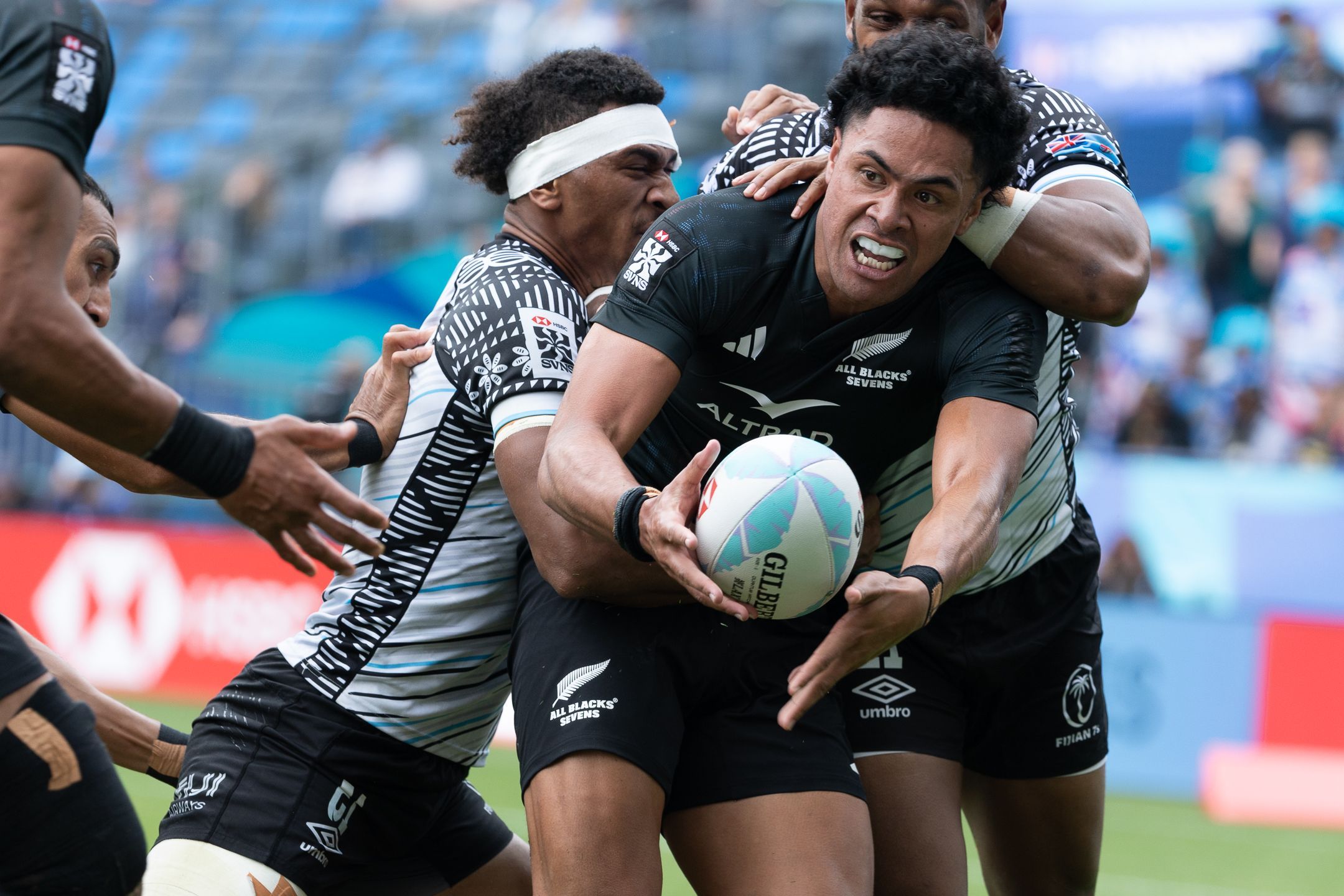 Elite rugby players in a match tackle
