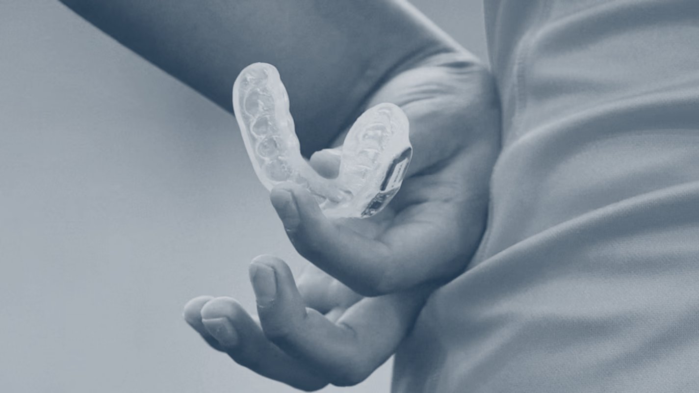 Athlete holding a Prevent instrumented mouthguard