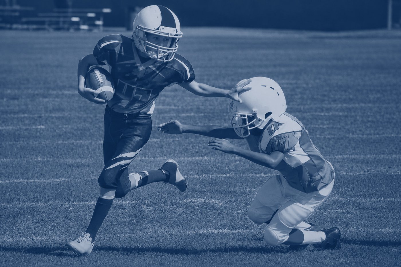 Youth football players in contact during a game